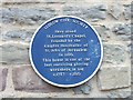 Blue plaque on a building in Linney