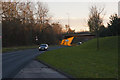 A bridge carrying the M58 catches the late afternoon sun