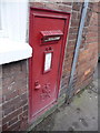 Newent: disused postbox in post office wall