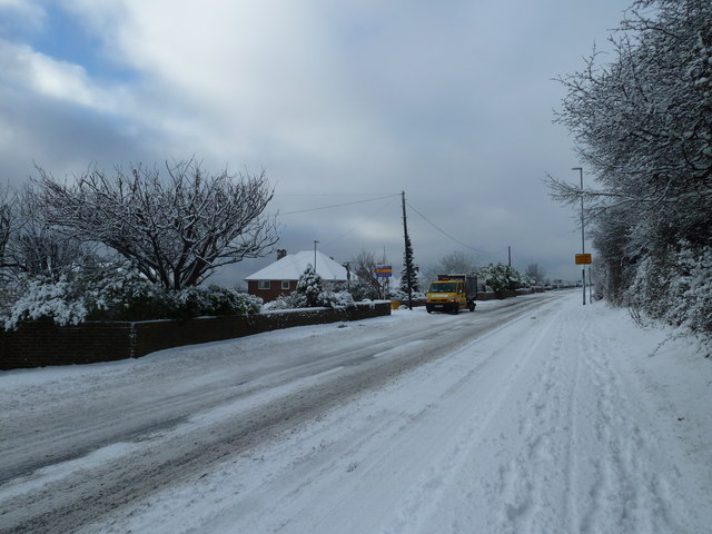 Approaching the junction of a snowy Portsdown Hill Road and Beverley Grove