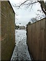 A snowy East Copsey Path emerges onto the Eastern Road