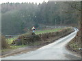 Hill and old style 1 in 6 road sign, near Coed-y-Paen