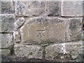 Benchmark on boundary wall of military school & barracks, Caernarfon