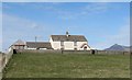 Boarded up farmhouse overlooking the sea