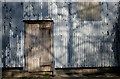 Old grey paint and an old door