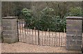 Gates onto Woolfords Lane from cemetery