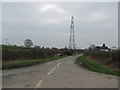 Pylons cross the road near White House Farm