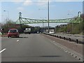 SJ9142 : A50 - footbridge east of the A5035 junction by Peter Whatley