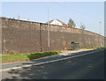 Bus shelter and long high wall, A48 near Llanbedr