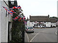 SW7728 : Bunting decorating cottages in the centre of Mawnan Smith village by Rod Allday