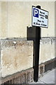 Benchmark and parking restriction sign on Holy Trinity Church