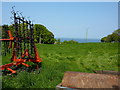 Field, farm equipment and Irish Sea