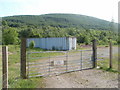 Old Furnace : locked gate, container and hillside view