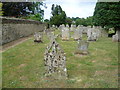 Lichen-encrusted gravestones in Glaston Churchyard