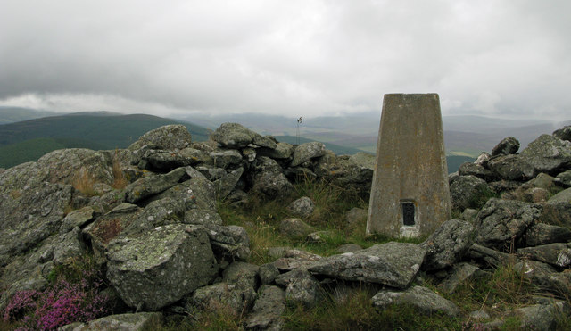 Trig point and rocks at summit of Ben Newe