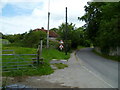 Footpath sign and stile in East Dean