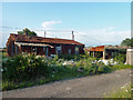 Derelict tin house and shed