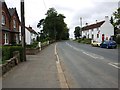 The road through Crathorne, with the Post Office on the right