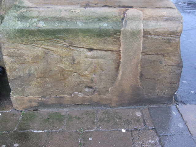 Weathered bench mark on Whitby station
