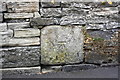 Benchmark on stone in wall of The Bailey opposite Overdale Court