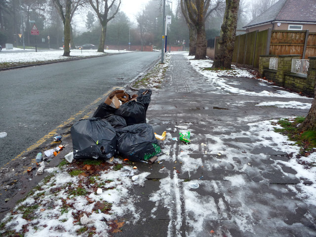 Bin bags awaiting collection on an icy Pebble Mill Road