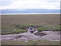 Boat in muddy creek of  the Dee salt marsh