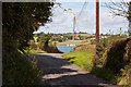 A road leaving Westleigh with a glimpse of the river Torridge