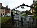 Looking through the church gate out towards Watling Street