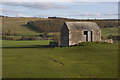 NY5122 : Field with barn by Ian Greig