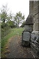 Headstone by the buttress