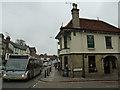 Bus passing The Crown on the Bridge