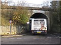 Single decker passing under School Lane bridge