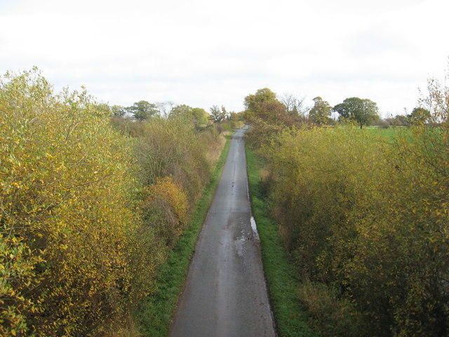 Looking East along Whatcroft Hall Lane from the railway bridge