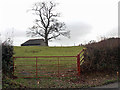 Mysterious building in a gated field