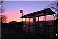 A bus shelter in silhouette