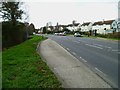 Bus stop opposite footpath on the B2145 at Hunston