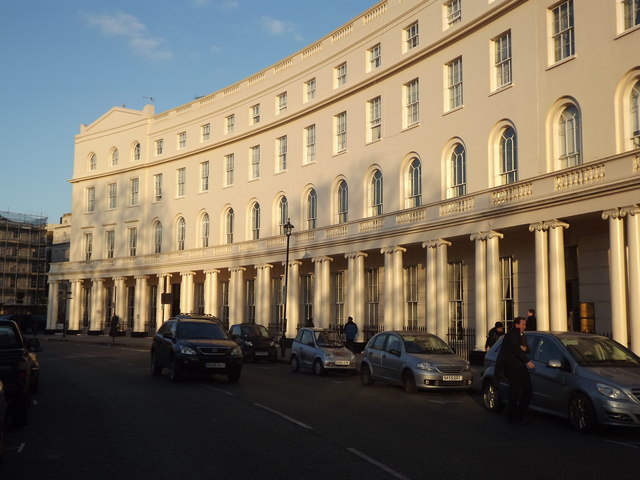 Park Crescent: A large light-colored building with four floors. The first of which has columns holding up a balcony to the second floor. 
