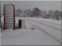 NT2320 : Red phone box outside Glen Cafe on a snowy day by Alan O'Dowd