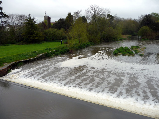 Silt-laden water rushing over a weir on the River Stour Blandford Dorset  England UK Stock Photo - Alamy