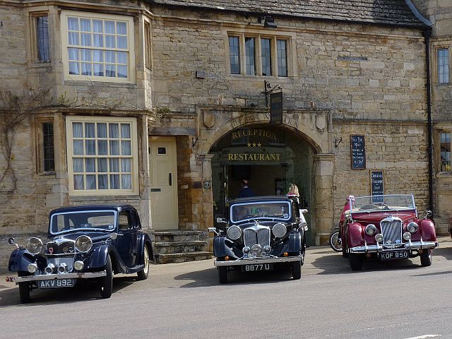 Three Riley cars parked outside The Bell