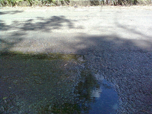 A new spring? Water welling through the road, near Tite Tap