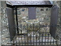 14th century font in the churchyard of  Eglwys Sant Tegfan, Llandegfan