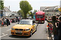 The lead vehicles in the Olympic Torch procession entering Western Terrace in Falmouth