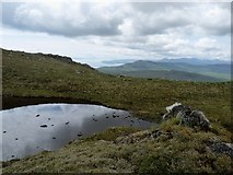 NM8050 : Lochan with sheep rubbing rock on Meall na FÃ¬dhle by Alan Reid