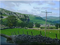 SD9767 : The Village of Kilnsey showing the overhang of the Crag by John M Wheatley