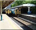 Two southbound trains waiting at Cardiff Queen Street railway station