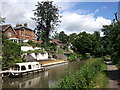 Houses backing onto the Kennet and Avon canal, at Devizes, boat Minstrel moored