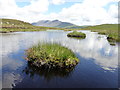 NR8937 : Small Loch just below Lochain Trig Point by Brian Robertson