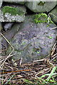 Benchmark on stone in wall on SE side of A686