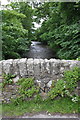 Walden Beck over the north parapet of Burton Bridge